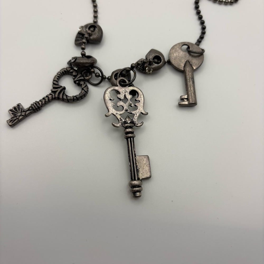 Silver-toned skull and key charm necklace